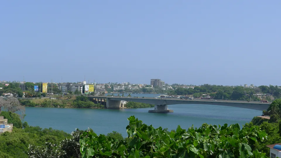A wide-angle view of the Nyali Bridge in Mombasa, Kenya, featuring modern architecture, lush green coastal landscapes, and bright daylight.